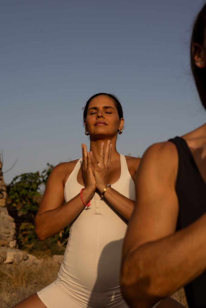 A guest in a seated yoga posture during an asana session